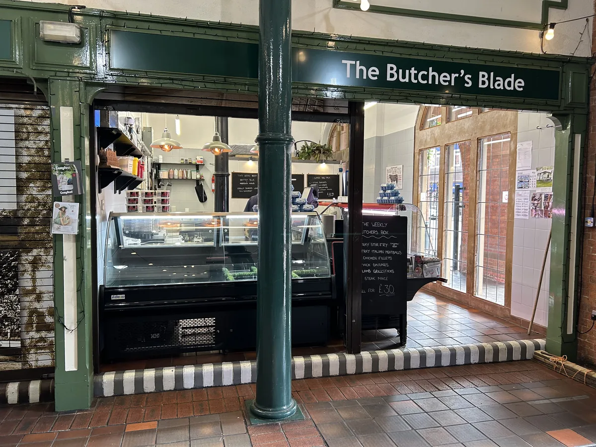 The Butcher’s Blade shop frontage at Sandbach Market Hall, beneath its green fascia sign