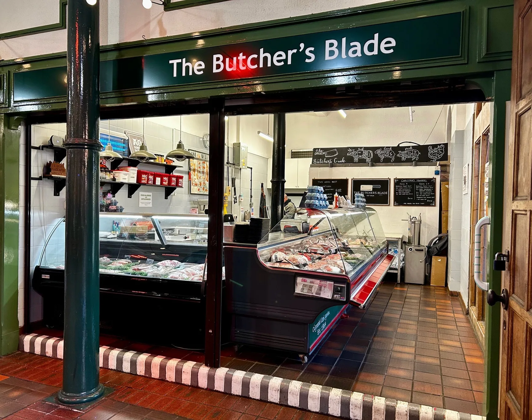 Chilled meat displays under The Butcher’s Blade sign at the Sandbach Market Hall counter