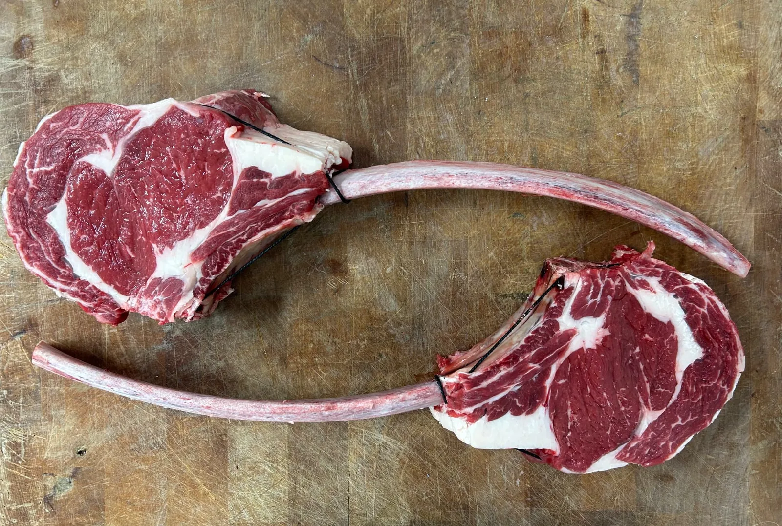 Two long-bone beef steaks on Lee’s butcher’s block in Sandbach